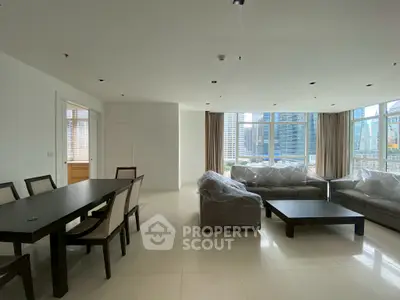 Spacious modern living room with city view, elegant dining area, and large windows for natural light.