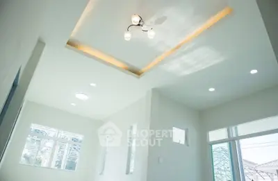 Bright modern living room with recessed lighting and large windows