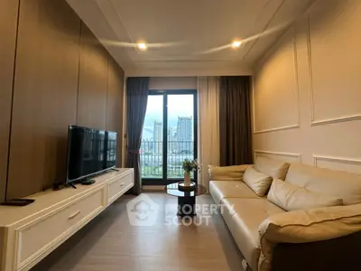 Modern living room with city view, featuring a sleek TV setup and elegant sofa.