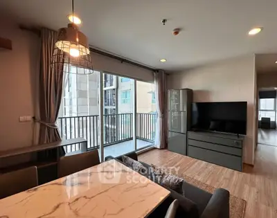 Modern living room with balcony view and stylish furniture in urban apartment.