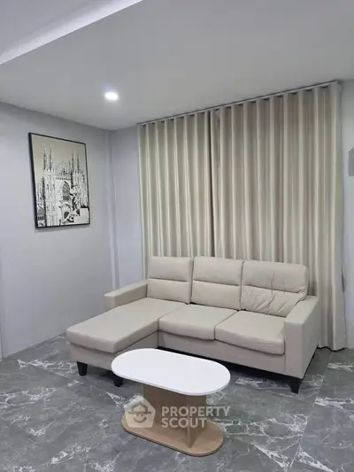 Modern living room with stylish beige sofa and elegant decor