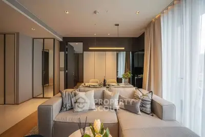 Modern living room with stylish decor and large windows in a luxury apartment.