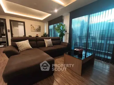 Luxurious living room with modern decor and large windows in a stylish apartment.