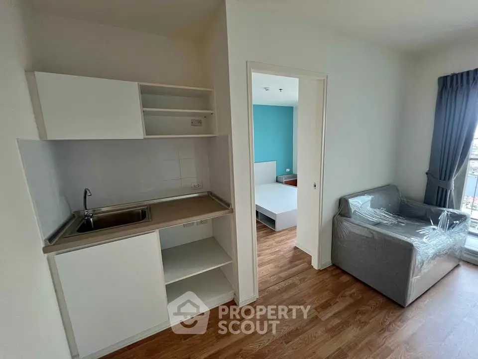 Modern apartment interior with compact kitchen and cozy living area