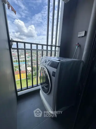 Compact balcony with washing machine and stunning city view, perfect for urban living convenience.