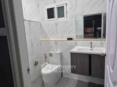 Modern bathroom with marble walls and sleek fixtures