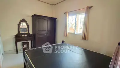 Cozy bedroom with large wardrobe and window view