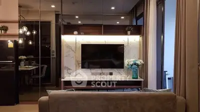 Modern living room with stylish decor and large TV