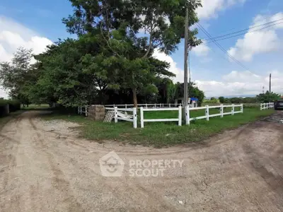 Scenic rural property with white fencing and lush greenery, ideal for countryside living.