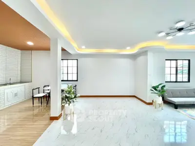 Spacious modern living room with stylish ceiling lights and open layout