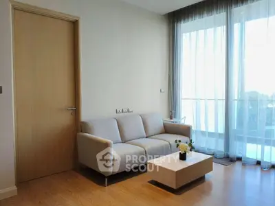 Modern living room with cozy sofa and natural light from large windows