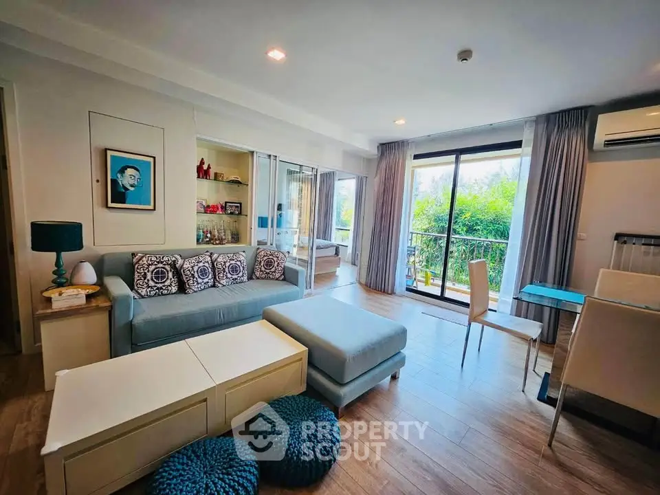 Spacious living room with modern decor and large windows for natural light