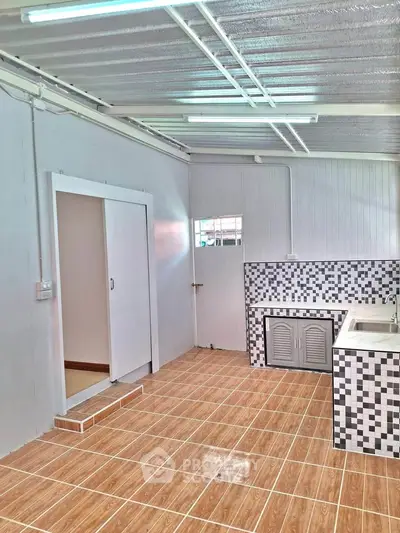Spacious kitchen with modern tile design and ample natural light