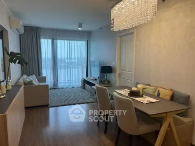 Elegant living room with dining area and large window offering stunning views.