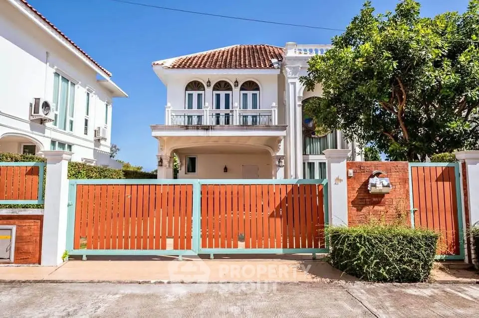 Charming two-story villa with elegant facade and spacious front yard in a serene neighborhood.