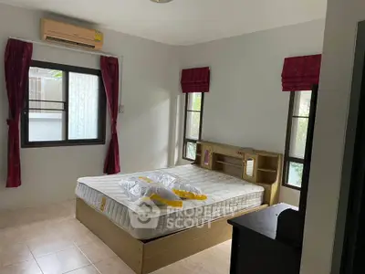 Cozy bedroom with natural light and modern furnishings, perfect for relaxation.