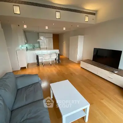 Spacious modern living room with open kitchen and sleek furnishings