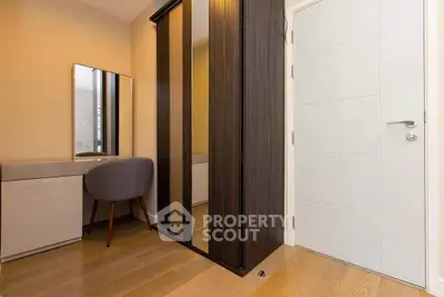 Modern bedroom with sleek wardrobe and stylish vanity area