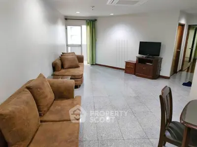 Spacious living room with cozy brown sofas and modern TV setup