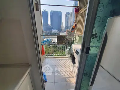 Charming balcony with laundry area and stunning city skyline view, perfect for urban living.