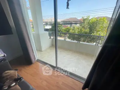 Spacious balcony with sliding glass doors and scenic neighborhood view