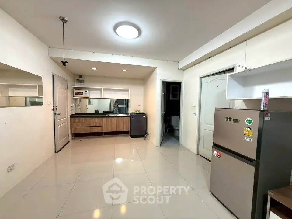 Modern kitchen with sleek appliances and open layout in a stylish apartment.