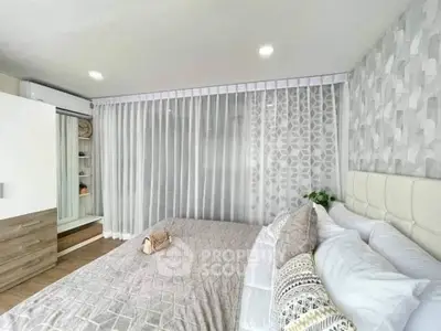 Modern bedroom with stylish decor and ample natural light