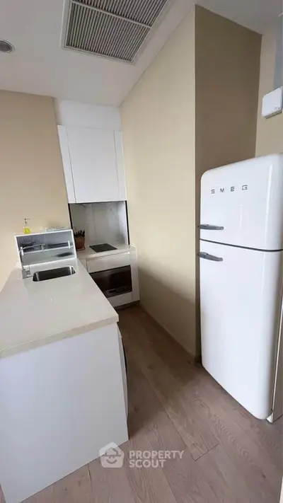 Modern kitchen with SMEG fridge and sleek white cabinetry