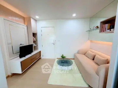 Modern living room with cozy sofa, stylish TV unit, and elegant decor in a bright apartment.