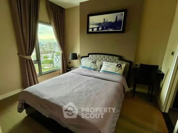 Cozy bedroom with city view, elegant decor, and natural light.
