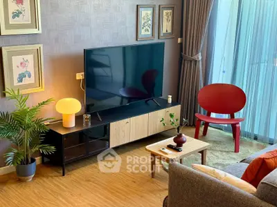 Stylish living room with modern decor, large TV, and elegant furniture, perfect for relaxation and entertainment.
