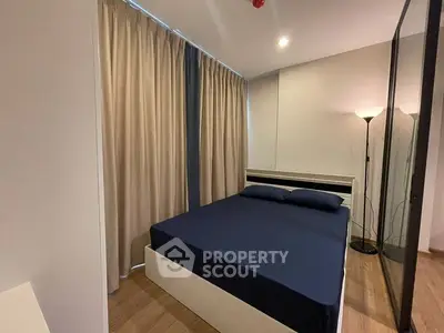 Cozy bedroom with modern decor and floor lamp, featuring a comfortable bed and elegant curtains.