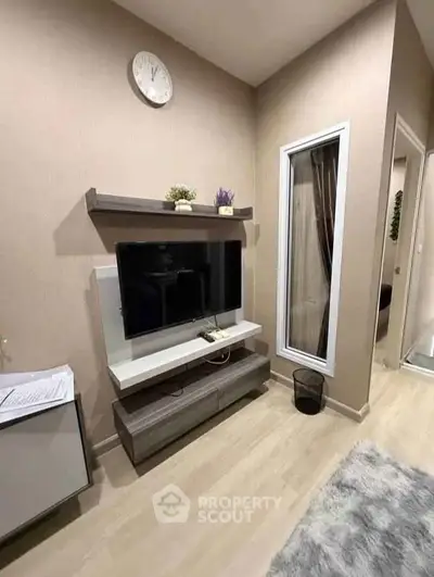 Modern living room with wall-mounted TV and stylish decor