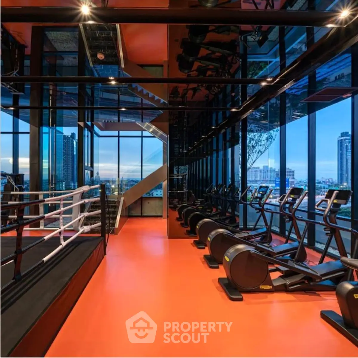 Luxurious gym with panoramic city views and modern fitness equipment.