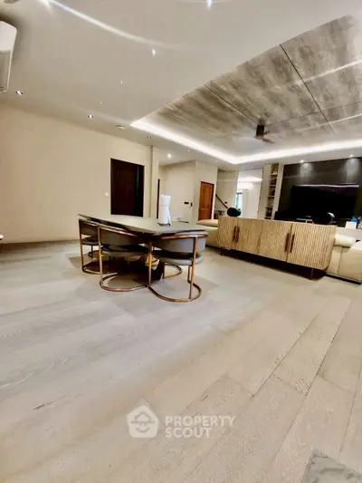 Modern living room with sleek furniture and stylish ceiling design