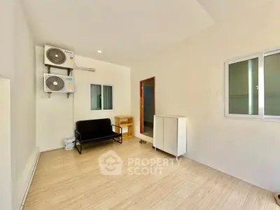 Spacious room with air conditioning and modern furnishings in a bright, minimalist style.