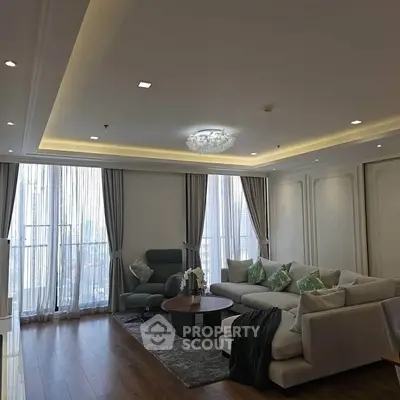 Luxurious living room with elegant decor and large windows offering natural light.