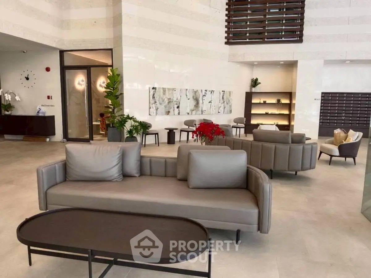 Luxurious modern lobby with elegant seating and contemporary decor in a high-end residential building.