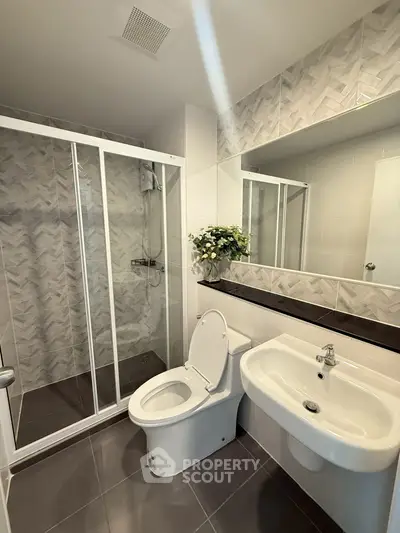 Modern bathroom with glass shower and sleek fixtures