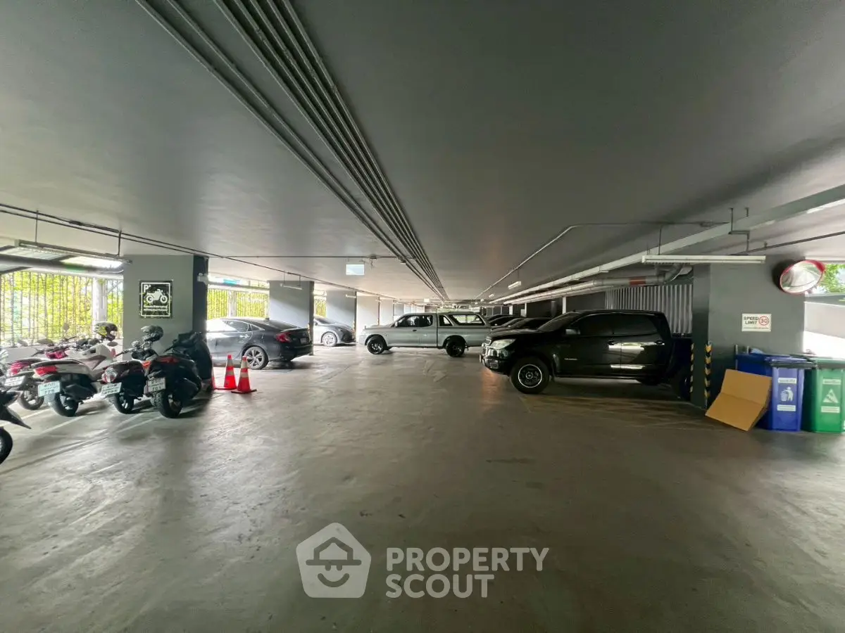 Spacious parking area with multiple vehicles and motorcycles, ideal for residential or commercial use.