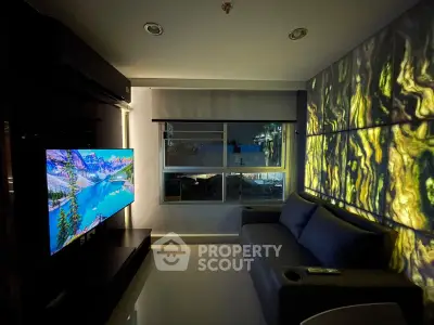 Modern living room with ambient lighting and city view, featuring a sleek sofa and large TV.