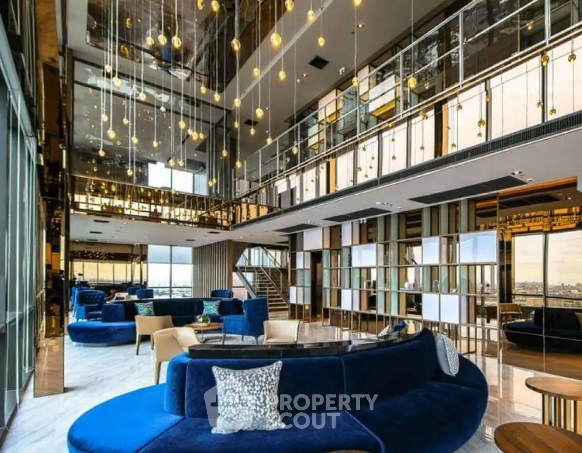 Luxurious modern living room with high ceilings and elegant blue sofas