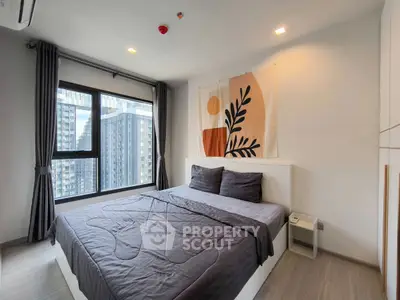 Modern bedroom with large window and stylish decor in urban apartment