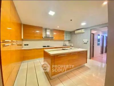 Spacious modern kitchen with sleek wooden cabinetry and island
