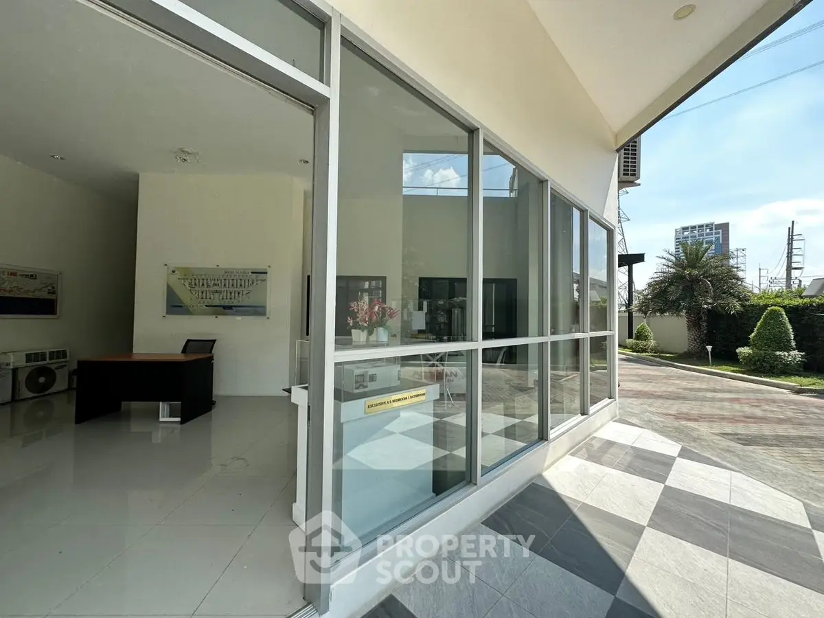 Modern office space with large windows and sleek design in a commercial building.