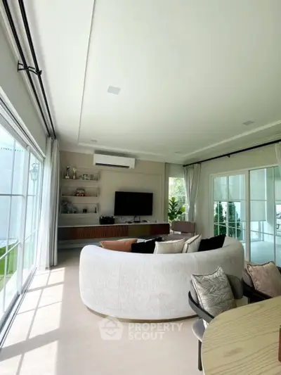 Spacious modern living room with large windows and stylish furniture