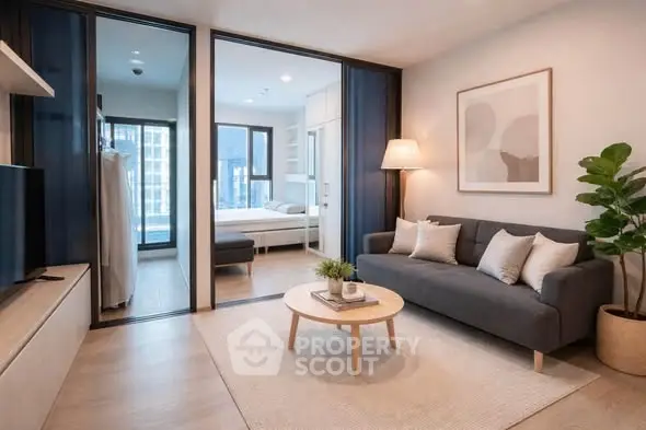Modern living room with cozy sofa, stylish decor, and view into bedroom in contemporary apartment.