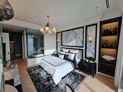 Luxurious bedroom with elegant decor and large windows offering natural light.