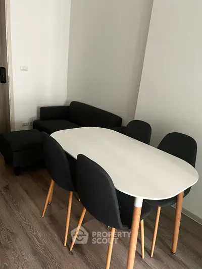 Modern dining area with sleek table and chairs in stylish apartment