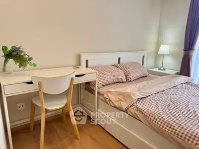 Cozy bedroom with stylish desk and comfortable bed in modern apartment.